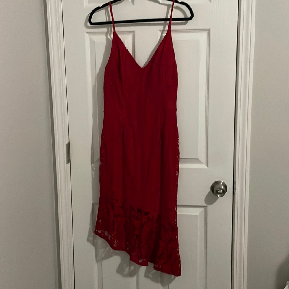 Sassy form fitting red lace dress with asymmetrical hem